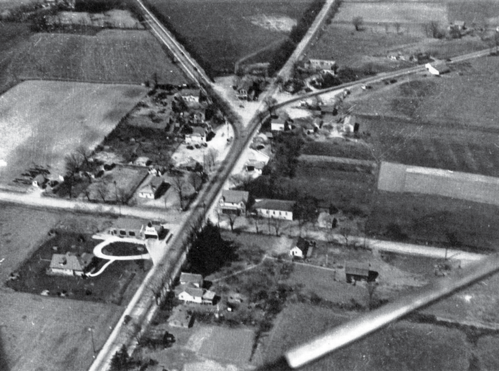 A birds-eye view of open land, except for a main roadway.